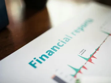 Handcuffs on financial documents representing COVID-19 support fraud investigation in The Hague