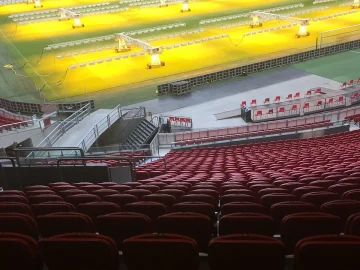 Empty stands and pitch-maintenance lights inside the Johan Cruijff ArenA in Amsterdam.