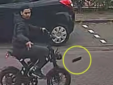 Still from police camera footage showing a young man riding away on a stolen fatbike in Diemen
