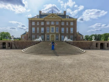 Historical books and archive documents illustrating research into Dutch royal support for colonialism